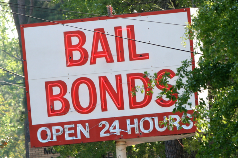 Sign displaying "Bail Bonds: Open 24 Hours)