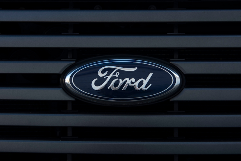 Image of grey grille and blue Ford logo on a Ford pickup truck.