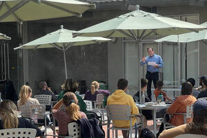Image of Center Director Ted Mermin speaking with students outside in Steinhart Courtyard at the Center's Fall 2021 new student orientation.